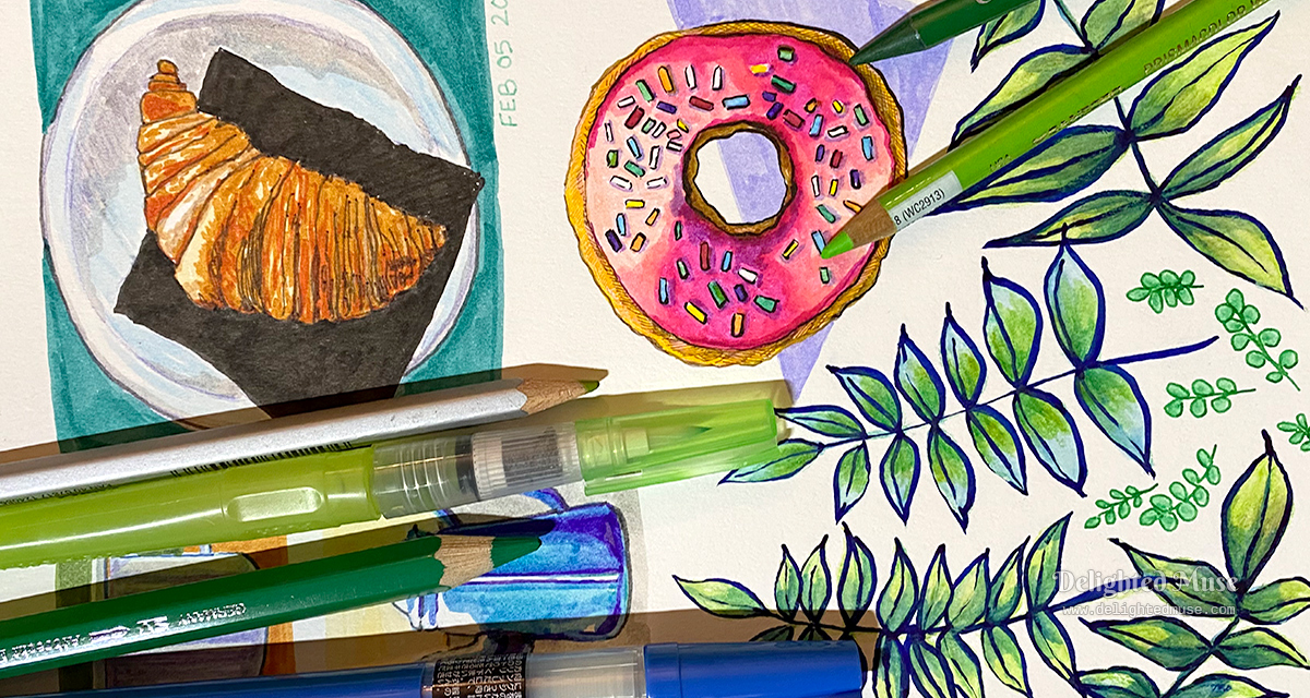 Sketchbook page showing drawings of a croissant, donut and leaves. Laid ontop are watercolor pencils, a water brush, and an ink brush.