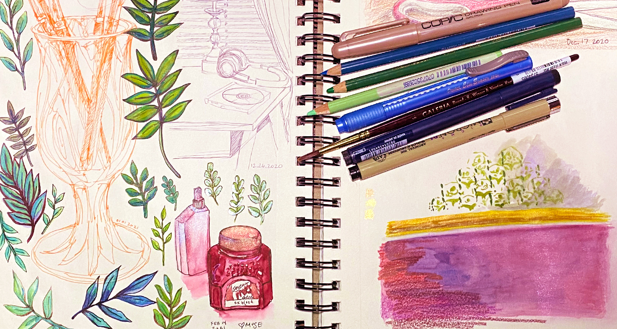 An open sketchbook with drawings of leaves and still life studies, pens and pencils are piles ontop of the right page