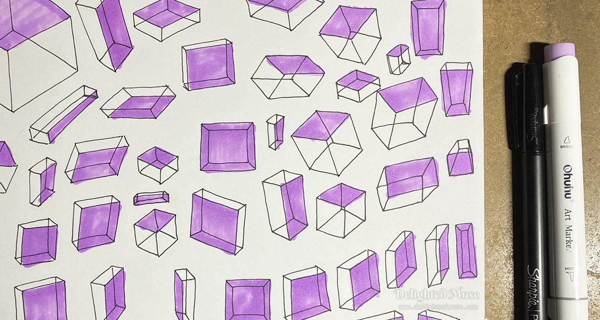 A close up of box drawings, with a pen and marker next to the drawing.