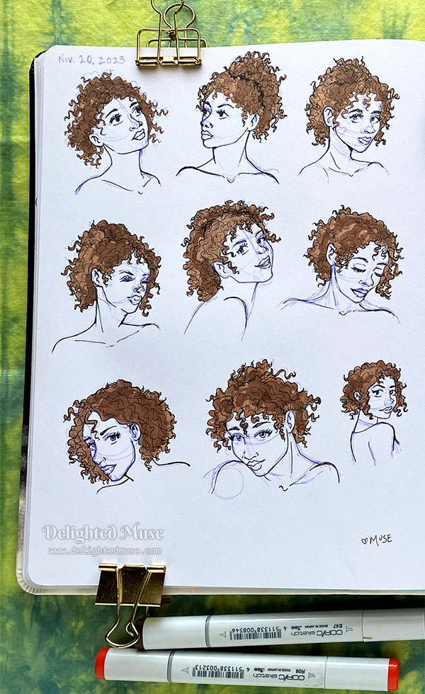 A photo of a sketchbook page, showing ink sketches of my character Lore, with brown kinky hair.