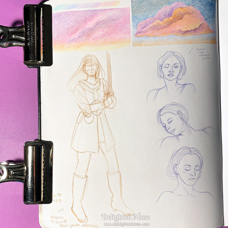 A sketchbook page with art clips holding the page down. At the top of the page are two pastel sunset cloud drawings. Below to the left is a rough sketch of a figure holding a sword, and to the right are three studies of a woman from shoulders up.
