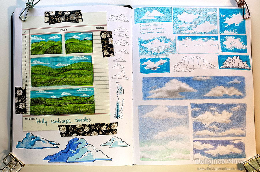 Photo of an open sketchbook spread. On the left page is ballpoint and gel pen doodles of hilly landscapes. On the right side are blue marker drawings of white puffy clouds.